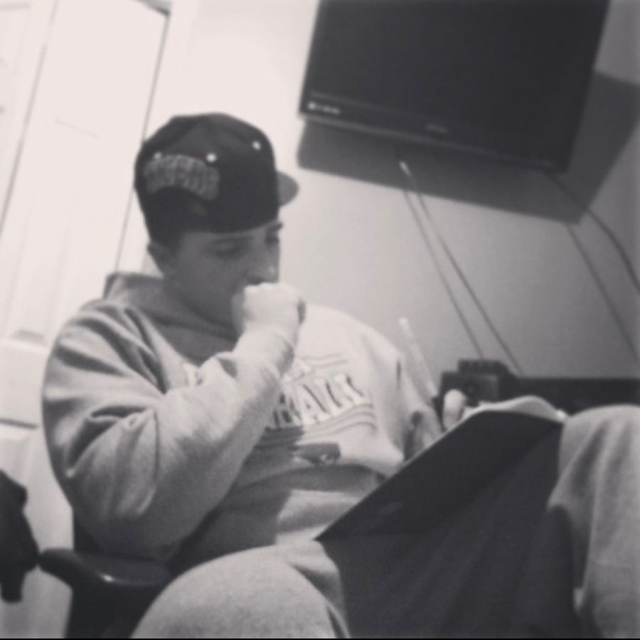 Writing lyrics in a notebook between sessions